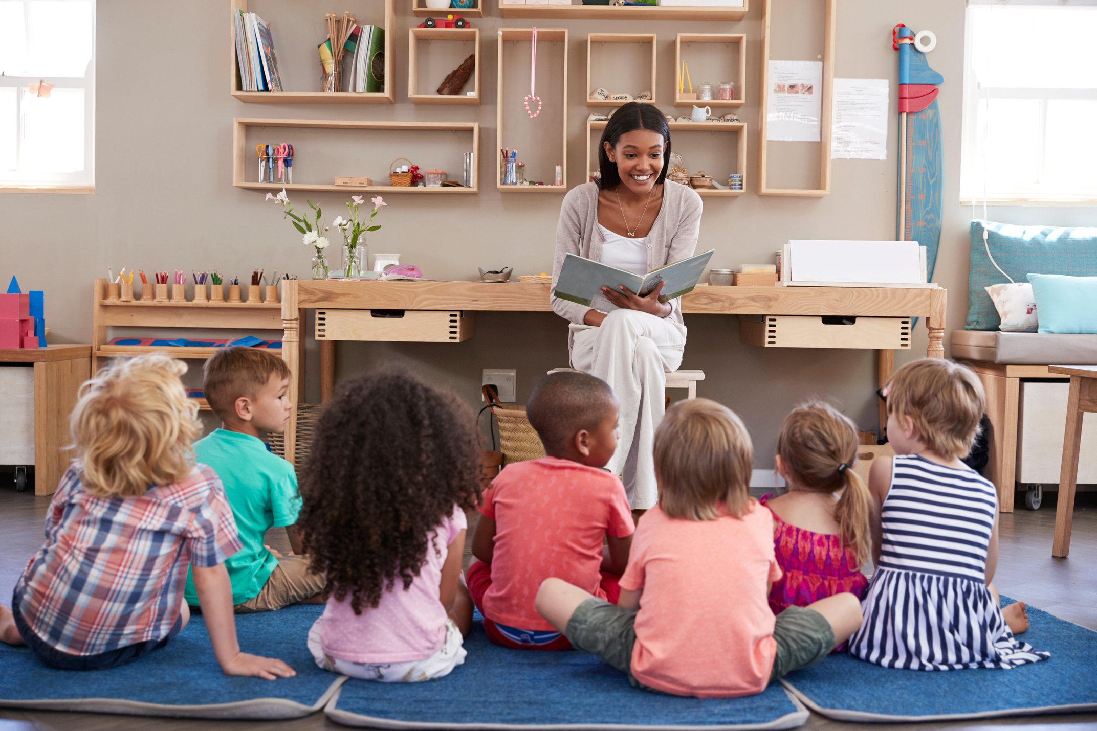 Teacher at Montessori School Reading to Children